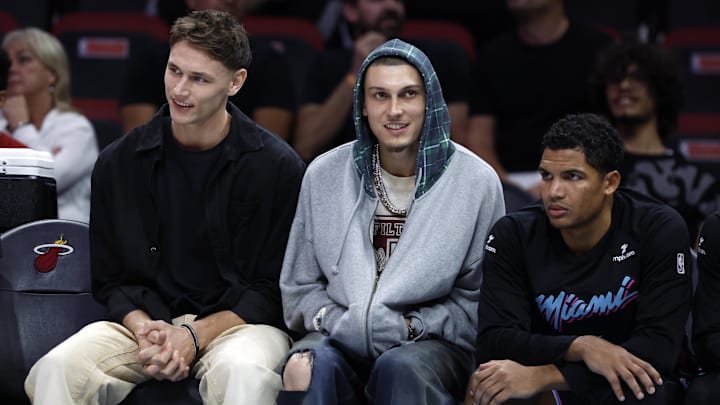 Dec 6, 2025; Miami, Florida, USA; Miami Heat guard Pelle Larsson, left, guard Tyler Herro, center, and guard Dru Smith, right, sit on the bench against the Sacramento Kings during the second half at Kaseya Center. Mandatory Credit: Rhona Wise-Imagn Images Dec 6, 2025; Miami, Florida, USA; Miami Heat guard Pelle Larsson, left, guard Tyler Herro, center, and guard Dru Smith, right, sit on the bench against the Sacramento Kings during the second half at Kaseya Center. Mandatory Credit: Rhona Wise-Imagn Images