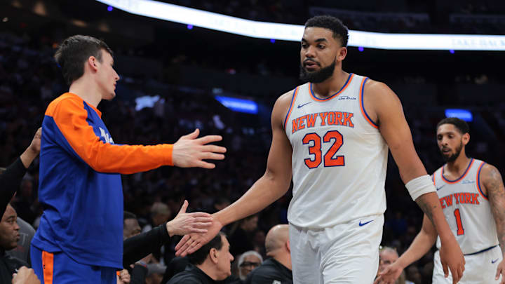 Mar 2, 2025; Miami, Florida, USA; New York Knicks center Karl-Anthony Towns (32) high-fives with teammates during the second quarter against the Miami Heat at Kaseya Center. Mandatory Credit: Sam Navarro-Imagn Images