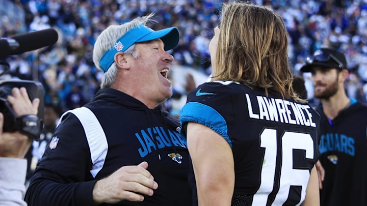 Jacksonville Jaguars head coach Doug Pederson celebrates with quarterback Trevor Lawrence (16) after