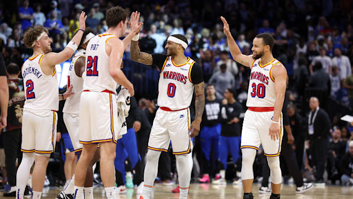Feb 27, 2025; Orlando, Florida, USA; Golden State Warriors guard Stephen Curry (30) celebrates with guard Gary Payton II (0) center Quinten Post (21) after a play against the Orlando Magic in the fourth quarter at Kia Center. Mandatory Credit: Nathan Ray Seebeck-Imagn Images