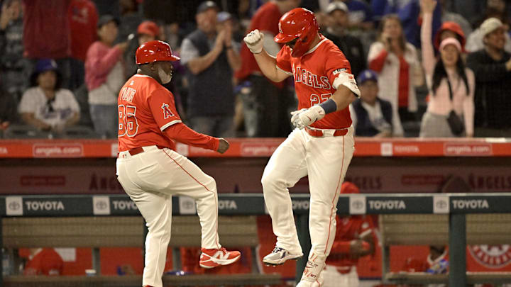Mar 24, 2025; Anaheim, California, USA; Los Angeles Angels center fielder Mike Trout (27) is greeted by third base coach Eric Young Sr. (85) after hitting a solo home run in the sixth inning against the Los Angeles Dodgers at Angel Stadium. Mandatory Credit: Jayne Kamin-Oncea-Imagn Images Mar 24, 2025; Anaheim, California, USA; Los Angeles Angels center fielder Mike Trout (27) is greeted by third base coach Eric Young Sr. (85) after hitting a solo home run in the sixth inning against the Los Angeles Dodgers at Angel Stadium. Mandatory Credit: Jayne Kamin-Oncea-Imagn Images