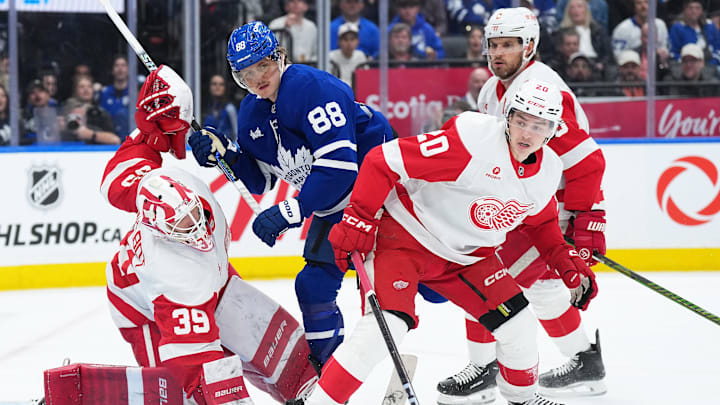 Apr 17, 2025; Toronto, Ontario, CAN; Toronto Maple Leafs right wing William Nylander (88) battles with Detroit Red Wings defenseman Albert Johansson (20) in front of goaltender Cam Talbot (39) during the third period at Scotiabank Arena. Mandatory Credit: Nick Turchiaro-Imagn Images