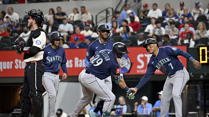 May 2, 2025; Arlington, Texas, USA; Seattle Mariners catcher Cal Raleigh (29) and designated hitter Jorge Polanco (7) and right fielder Rhylan Thomas (31) and center fielder Julio Rodriguez (44) celebrate after Raleigh hits a grand slam against the Texas Rangers during the fifth inning at Globe Life Field. Mandatory Credit: Jerome Miron-Imagn Images