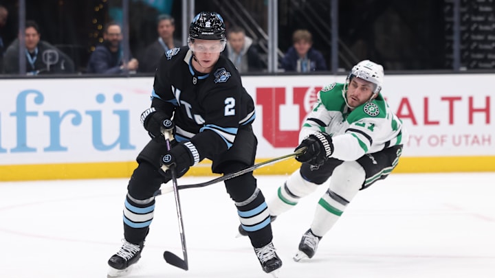 Dec 23, 2024; Salt Lake City, Utah, USA;  Utah Hockey Club defenseman Olli Maatta (2) and Dallas Stars left wing Mason Marchment (27) battle for the puck during the first period at Delta Center. Mandatory Credit: Rob Gray-Imagn Images