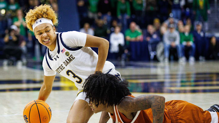 Notre Dame guard Hannah Hidalgo, left, winces after colliding with Texas guard Rori Harmon for possession of the ball during a NCAA women's basketball game at Purcell Pavilion on Thursday, Dec. 5, 2024, in South Bend. Notre Dame guard Hannah Hidalgo, left, winces after colliding with Texas guard Rori Harmon for possession of the ball during a NCAA women's basketball game at Purcell Pavilion on Thursday, Dec. 5, 2024, in South Bend.