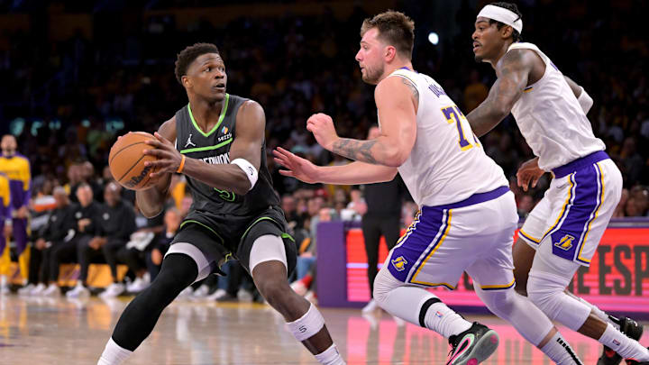 Apr 19, 2025; Los Angeles, California, USA; Minnesota Timberwolves guard Anthony Edwards (5) is defended by Los Angeles Lakers guard Luka Doncic (77) in the second half at Crypto.com Arena.