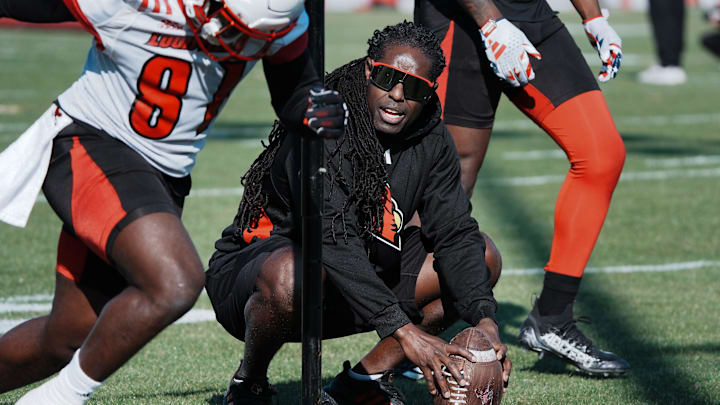 Louisville Wide Receivers Coach Deion Branch runs his squad through drills during practice outside the Trager Center in Louisville, Ky. on Mar. 1, 2025. Louisville Wide Receivers Coach Deion Branch runs his squad through drills during practice outside the Trager Center in Louisville, Ky. on Mar. 1, 2025.