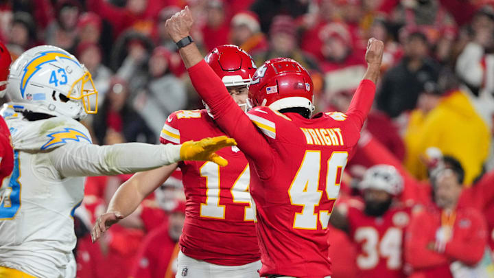 Dec 8, 2024; Kansas City, Missouri, USA; Kansas City Chiefs place kicker Matthew Wright (49) celebrates with punter Matt Araiza (14) after kicking the winning field goal against the Los Angeles Chargers during the second half at GEHA Field at Arrowhead Stadium. Mandatory Credit: Denny Medley-Imagn Images