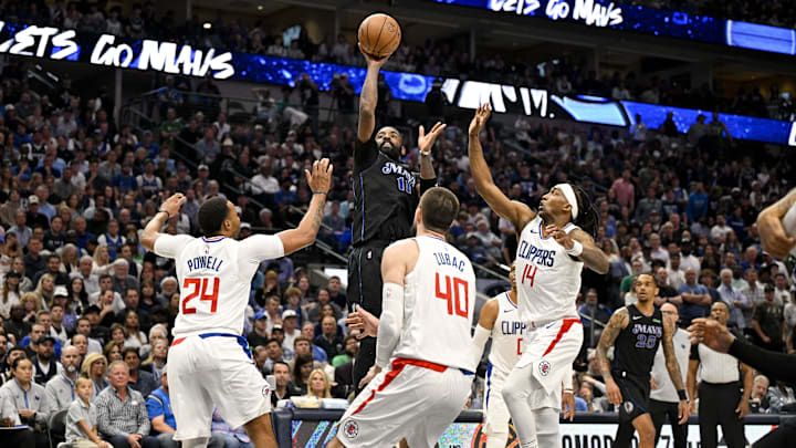 Dallas Mavericks guard Kyrie Irving (11) shoots the ball over LA Clippers guard Norman Powell (24) and center Ivica Zubac (40) and guard Terance Mann (14) during the third quarter during game six of the first round for the 2024 NBA playoffs at American Airlines Center. Mandatory Credit: Jerome Miron-Imagn Images Dallas Mavericks guard Kyrie Irving (11) shoots the ball over LA Clippers guard Norman Powell (24) and center Ivica Zubac (40) and guard Terance Mann (14) during the third quarter during game six of the first round for the 2024 NBA playoffs at American Airlines Center. Mandatory Credit: Jerome Miron-Imagn Images