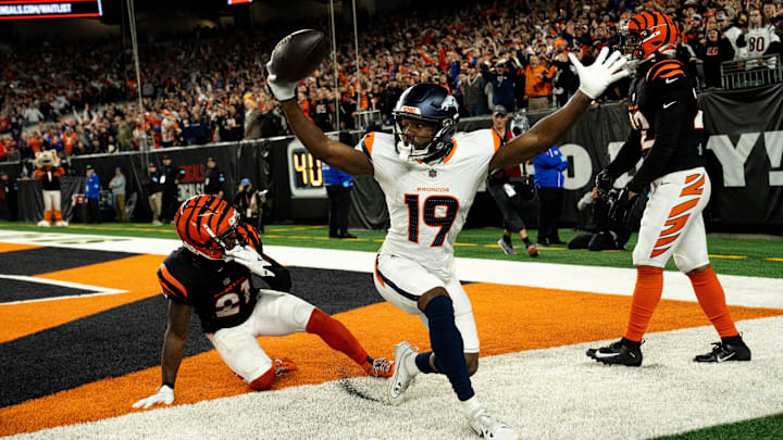 Denver Broncos wide receiver Marvin Mims Jr. (19) reacts to scoring a touchdown as Cincinnati Bengals cornerback Mike Hilton (21) and Cincinnati Bengals safety Geno Stone (22) look on with 8 seconds left in the fourth quarter of the NFL game at Paycor Stadium in Cincinnati on Saturday, Dec. 28, 2024. Denver Broncos wide receiver Marvin Mims Jr. (19) reacts to scoring a touchdown as Cincinnati Bengals cornerback Mike Hilton (21) and Cincinnati Bengals safety Geno Stone (22) look on with 8 seconds left in the fourth quarter of the NFL game at Paycor Stadium in Cincinnati on Saturday, Dec. 28, 2024.
