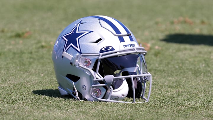 Aug 17, 2022; Costa Mesa, CA, USA; A Dallas Cowboys helmet with Oakley visor sits on the field during joint practice against the Los Angeles Chargers at Jack Hammett Sports Complex. Mandatory Credit: Kirby Lee-Imagn Images