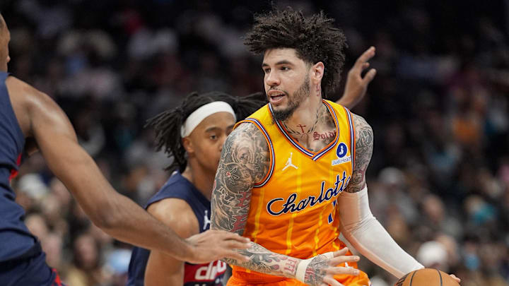 Jan 24, 2026; Charlotte, North Carolina, USA; Charlotte Hornets guard LaMelo Ball (1) handles the ball against Washington Wizards center Alex Sarr (20) and guard Tre Johnson (12) during the second half at the Spectrum Center. Mandatory Credit: Jim Dedmon-Imagn Images