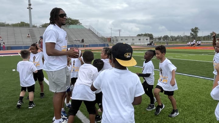 Missouri Tigers wide receiver Luther Burden III speaks to participants at his youth football camp at East St. Louis High School. Missouri Tigers wide receiver Luther Burden III speaks to participants at his youth football camp at East St. Louis High School.