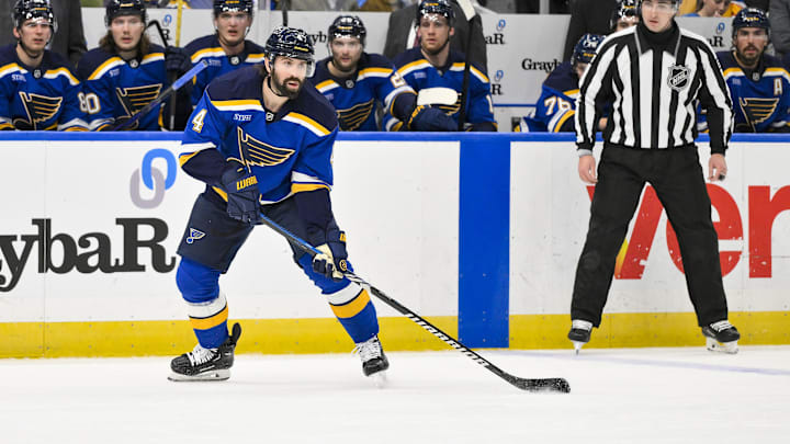 Feb 4, 2025; St. Louis, Missouri, USA;  St. Louis Blues defenseman Nick Leddy (4) controls the puck against the Edmonton Oilers during the second period at Enterprise Center. Mandatory Credit: Jeff Curry-Imagn Images
