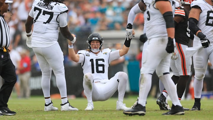 Jacksonville Jaguars quarterback Trevor Lawrence (16) is helped by offensive tackle Anton Harrison (77) and offensive tackle Cam Robinson (74) after being sacked during the third quarter of an NFL football matchup Sunday, Sept. 15, 2024 at EverBank Stadium in Jacksonville, Fla. The Browns defeated the Jaguars 18-13.