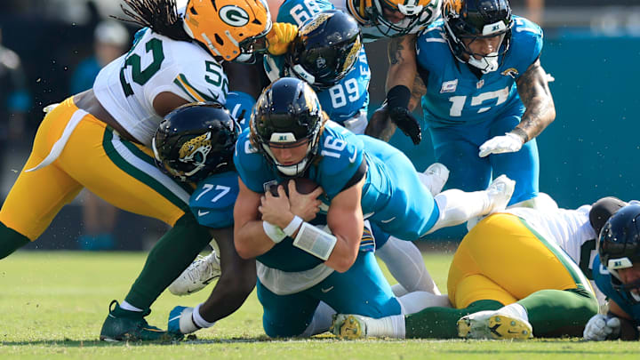 Jacksonville Jaguars quarterback Trevor Lawrence (16) leaps for a first down during the third quarter of an NFL football matchup Sunday, Oct. 27, 2024 at EverBank Stadium in Jacksonville, Fla. The Packers edged the Jaguars 30-27 on a last-second field goal. [Corey Perrine/Florida Times-Union]