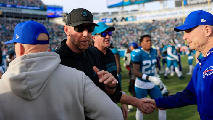 Jacksonville Jaguars head coach Liam Coen, center left, greets Buffalo Bills head coach Sean McDermott after the game of an NFL football AFC Wild Card playoff matchup, Sunday, Jan. 11, 2026, in Jacksonville, Fla. The Bills defeated the Jaguars 27-24. [Corey Perrine/Florida Times-Union]