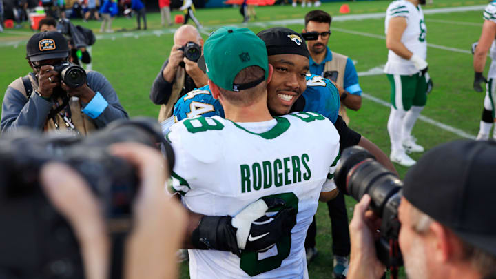 New York Jets quarterback Aaron Rodgers (8) is hugged by Jacksonville Jaguars defensive end Travon Walker (44) after the game Sunday, Dec. 15, 2024 at EverBank Stadium in Jacksonville, Fla. The Jets held off the Jaguars 32-25. [Corey Perrine/Florida Times-Union]