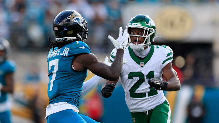 Jacksonville Jaguars wide receiver Brian Thomas Jr. (7) hauls in a reception against New York Jets cornerback Brandon Stephens (21) during the third quarter of a NFL football matchup at EverBank Stadium, Sunday, Dec. 14, 2025, in Jacksonville, Fla. The Jaguars defeated the Jets 48-20. [Corey Perrine/Florida Times-Union]