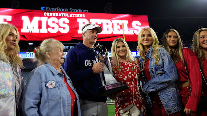 Jan. 2, 2025: Ole Miss Rebels head coach Lane Kiffin poses with his family, including daughter Landry in the jean jacket, after winning the Gator Bowl. Jan. 2, 2025: Ole Miss Rebels head coach Lane Kiffin poses with his family, including daughter Landry in the jean jacket, after winning the Gator Bowl.
