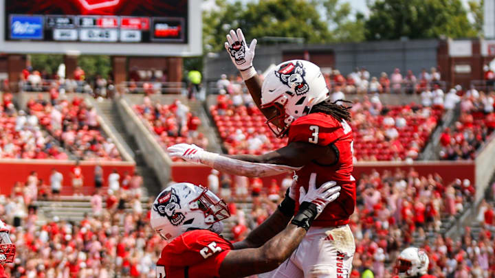 Sep 6, 2025; Raleigh, North Carolina, USA; North Carolina State Wolfpack running back Hollywood Smothers (3), and offensive lineman Jacarrius Peak (65) celebrate a touchdown during the second half of the game against Virginia Cavaliers at Carter-Finley Stadium. Mandatory Credit: Jaylynn Nash-Imagn Images