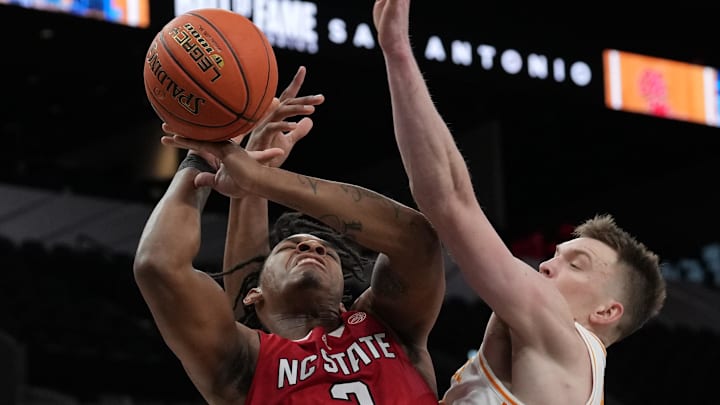 Dec 16, 2023; San Antonio, Texas, USA; North Carolina State Wolfpack guard MJ Rice (3) shoots in front of Tennessee Volunteers guard Dalton Knecht (3) in the first half at the Frost Bank Center. Mandatory Credit: Daniel Dunn-Imagn Images Dec 16, 2023; San Antonio, Texas, USA; North Carolina State Wolfpack guard MJ Rice (3) shoots in front of Tennessee Volunteers guard Dalton Knecht (3) in the first half at the Frost Bank Center. Mandatory Credit: Daniel Dunn-Imagn Images
