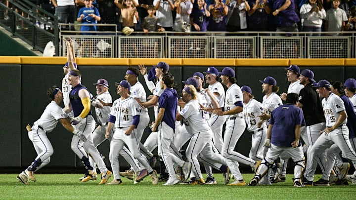 Jun 18, 2025; Omaha, Neb, USA;  LSU Tigers players celebrate with first baseman Jared Jones (22) (no shirt) after the win against the Arkansas Razorbacks at Charles Schwab Field. Mandatory Credit: Steven Branscombe-Imagn Images