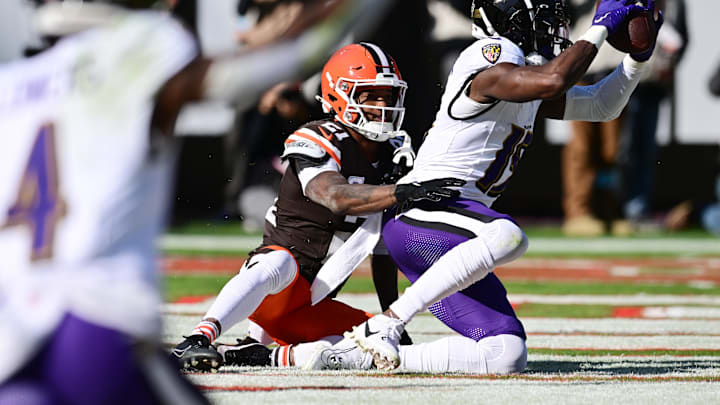 Oct 27, 2024; Cleveland, Ohio, USA; Baltimore Ravens wide receiver Nelson Agholor (15) catches a touchdown as Cleveland Browns cornerback Denzel Ward (21) defends during the first half at Huntington Bank Field. Mandatory Credit: Ken Blaze-Imagn Images