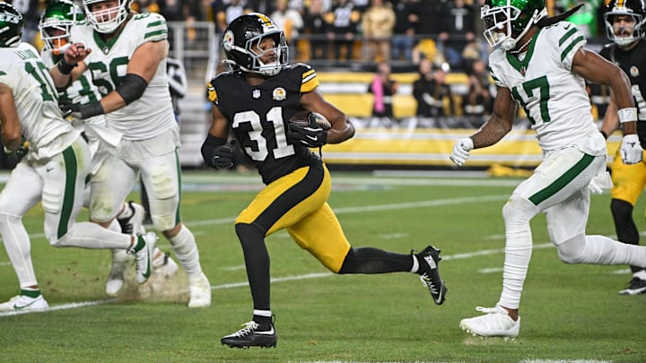 Oct 20, 2024; Pittsburgh, Pennsylvania, USA; Pittsburgh Steelers cornerback Beanie Bishop Jr. (31) returns an interception while being chased by New York Jets wide receiver Davante Adams (17) during the third quarter at Acrisure Stadium. Mandatory Credit: Barry Reeger-Imagn Images