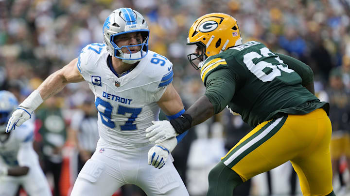 Sep 7, 2025; Green Bay, Wisconsin, USA; Detroit Lions defensive end Aidan Hutchinson (97) fights for position with Green Bay Packers offensive tackle Rasheed Walker (63) during the second quarter at Lambeau Field. Mandatory Credit: Jeff Hanisch-Imagn Images