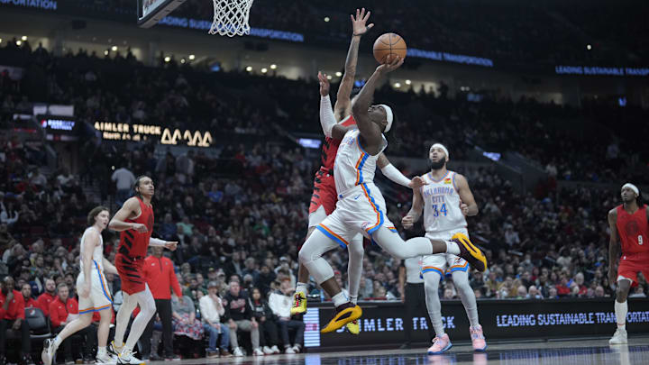 Mar 6, 2024; Portland, Oregon, USA; Oklahoma City Thunder guard Luguentz Dort (5) shoots the ball against Portland Trail Blazers shooting guard Anfernee Simons (1, behind) during the second half at Moda Center. Mandatory Credit: Soobum Im-Imagn Images Mar 6, 2024; Portland, Oregon, USA; Oklahoma City Thunder guard Luguentz Dort (5) shoots the ball against Portland Trail Blazers shooting guard Anfernee Simons (1, behind) during the second half at Moda Center. Mandatory Credit: Soobum Im-Imagn Images