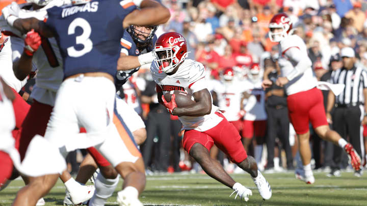 Oct 12, 2024; Charlottesville, Virginia, USA; Louisville Cardinals running back Isaac Brown (25) carries the ball to score a touchdown during the first half against the Virginia Cavaliers at Scott Stadium. Mandatory Credit: Amber Searls-Imagn Images