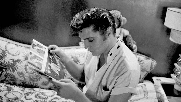 Elvis Presley reading a magazine at home Elvis Presley reading a magazine at home