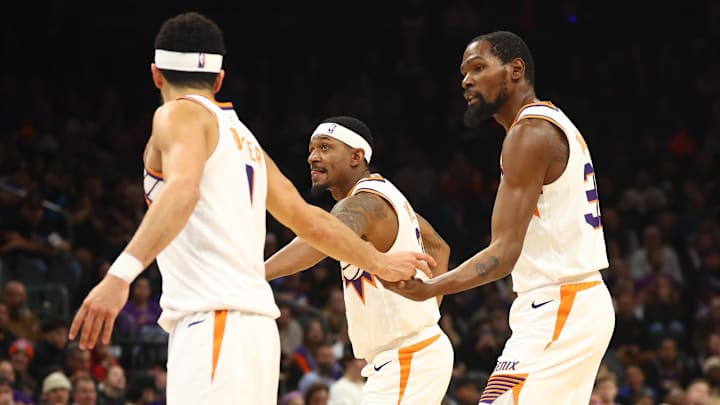 Dec 13, 2023; Phoenix, Arizona, USA; Phoenix Suns guard Devin Booker with guard Bradley Beal (3) and forward Kevin Durant (35) against the Brooklyn Nets at Footprint Center. Mandatory Credit: Mark J. Rebilas-Imagn Images