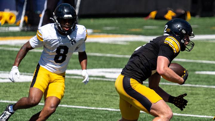 Iowa defensive backs Deshaun Lee (8) and Zach Lutmer (6) defend wide receiver Reece Vander Zee (2) as he runs for extra yards after a catch April 25, 2026 during the team’s spring practice at Kinnick Stadium in Iowa City, Iowa.