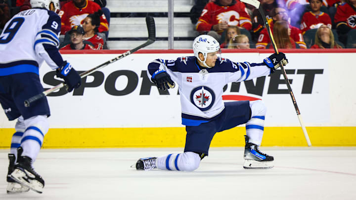 Oct 26, 2024; Calgary, Alberta, CAN; Winnipeg Jets center Cole Perfetti (91) celebrates his goal with teammates against the Calgary Flames during the third period at Scotiabank Saddledome. Mandatory Credit: Sergei Belski-Imagn Images