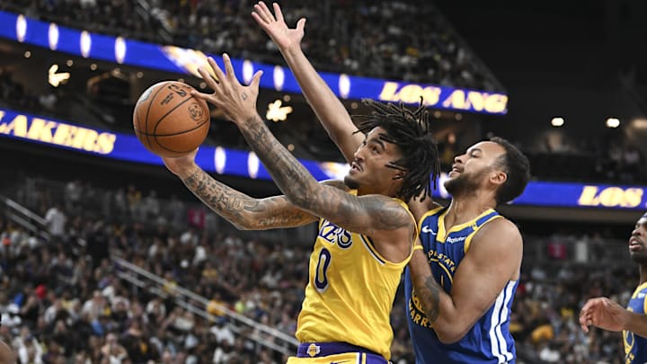 Oct 15, 2024; Las Vegas, Nevada, USA; Los Angeles Lakers guard Jalen Hood-Schifino (0) tries to score on Golden State Warriors forward Kyle Anderson (1) in the third quarter during a preseason game at T-Mobile Arena. Mandatory Credit: Candice Ward-Imagn Images