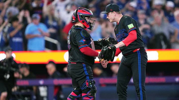 Toronto Blue Jays catcher Alejandro Kirk celebrates the win with relief pitcher Louis Varland. Toronto Blue Jays catcher Alejandro Kirk celebrates the win with relief pitcher Louis Varland.