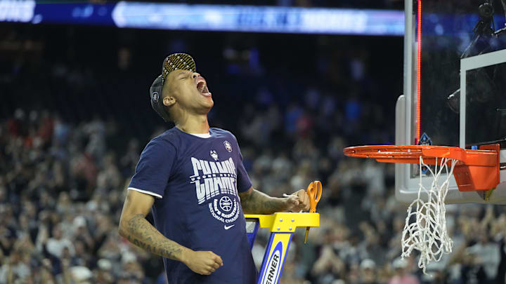 Apr 3, 2023; Houston, TX, USA; Connecticut Huskies guard Jordan Hawkins (24) celebrates with cutting the net after defeating the San Diego State Aztecs in the national championship game of the 2023 NCAA Tournament at NRG Stadium. Mandatory Credit: Bob Donnan-Imagn Images
