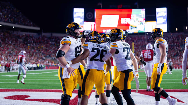 Oct 11, 2025; Madison, Wisconsin, USA; Iowa Hawkeyes running back Xavier Williams (26) celebrates a touchdown with his teammates in the second half against the Wisconsin Badgers at Camp Randall Stadium. Mandatory Credit: Ross Harried-Imagn Images