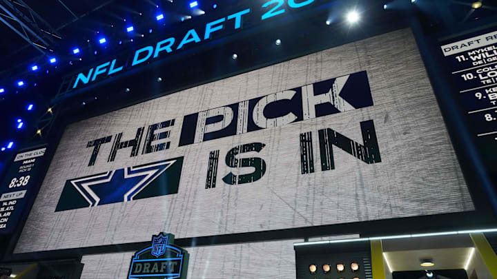 The Dallas Cowboys logo is projected on the video board during the NFL Draft at Lambeau Field
