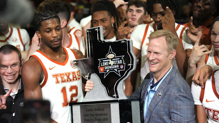 Jan 25, 2025; Austin, Texas, USA; Texas Longhorns guard Tramon Mark (12) holds the Lone Star Showdown trophy after a victory over the Texas A&M Aggies at Moody Center. Mandatory Credit: Scott Wachter-Imagn Images Jan 25, 2025; Austin, Texas, USA; Texas Longhorns guard Tramon Mark (12) holds the Lone Star Showdown trophy after a victory over the Texas A&M Aggies at Moody Center. Mandatory Credit: Scott Wachter-Imagn Images