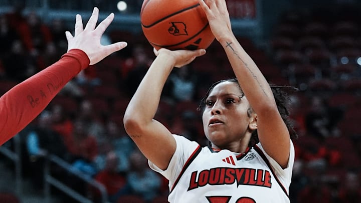 Louisville's Jayda Curry (30) fires a jumper against Oklahoma during their game at the KFC Yum! Center in Louisville, Ky. on Dec. 4, 2024.