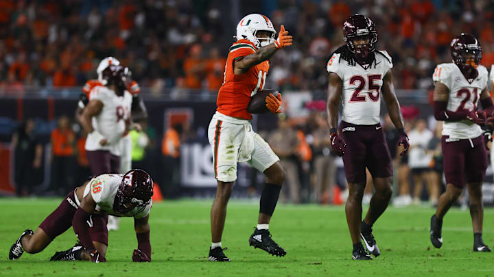 Sep 27, 2024; Miami Gardens, Florida, USA; Miami Hurricanes wide receiver Samuel Brown (11) reacts after running with the football against the Virginia Tech Hokies during the fourth quarter at Hard Rock Stadium. Mandatory Credit: Sam Navarro-Imagn Images
