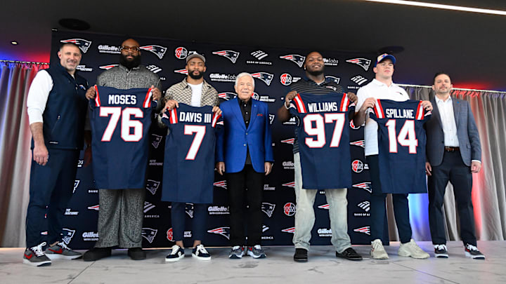Mar 13, 2025; Foxborough, MA, USA; The New England Patriots hold a press conference at the GP Atrium at Gillette Stadium to introduce free agency additions to the team. (Left to right) New England Patriots head coach Mike Vrabel, offensive tackle Morgan Moses, cornerback Carlton Davis III, owner Robert Kraft, defensive tackle Milton Williams, linebacker Robert Spillane and executive vice president of player personnel Eliot Wolf. Mandatory Credit: Eric Canha-Imagn Images