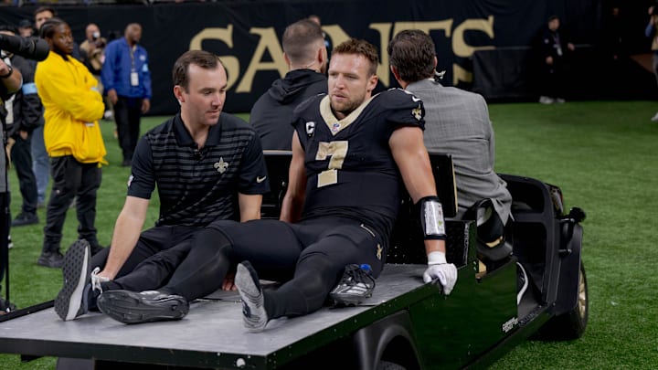 Dec 1, 2024; New Orleans, Louisiana, USA; New Orleans Saints tight end Taysom Hill (7) leaves the field after an injury against the Los Angeles Rams during the second half at Caesars Superdome. Mandatory Credit: Matthew Hinton-Imagn Images