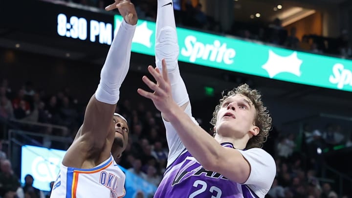Feb 6, 2024; Salt Lake City, Utah, USA; Utah Jazz forward Lauri Markkanen (23) lays the ball up against Oklahoma City Thunder guard Shai Gilgeous-Alexander (2) during the third quarter at Delta Center. Mandatory Credit: Rob Gray-USA TODAY Sports