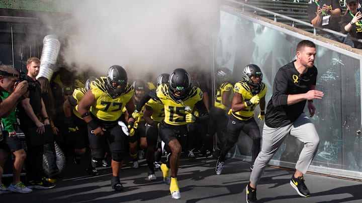 Oregon coach Dan Lanning leads his team onto the field veer their game against Illinois at Autzen Stadium in Eugene Saturday, Oct 26, 2024.