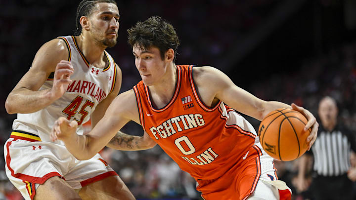 Mar 8, 2026; College Park, Maryland, USA;  Illinois Fighting Illini forward David Mirkovic (0) drives to the basket on Maryland Terrapins center Collin Metcalf (45) during the first half at Xfinity Center. Mandatory Credit: Tommy Gilligan-Imagn Images