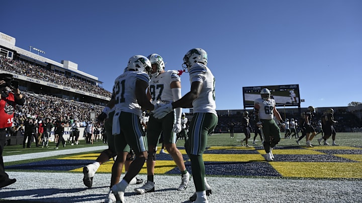 Nov 16, 2024; Annapolis, Maryland, USA; Tulane Green Wave running back Makhi Hughes (21) celebrates with teammates after scoring a second quarter touchdown against the Navy Midshipmen at Navy-Marine Corps Memorial Stadium. Nov 16, 2024; Annapolis, Maryland, USA; Tulane Green Wave running back Makhi Hughes (21) celebrates with teammates after scoring a second quarter touchdown against the Navy Midshipmen at Navy-Marine Corps Memorial Stadium.